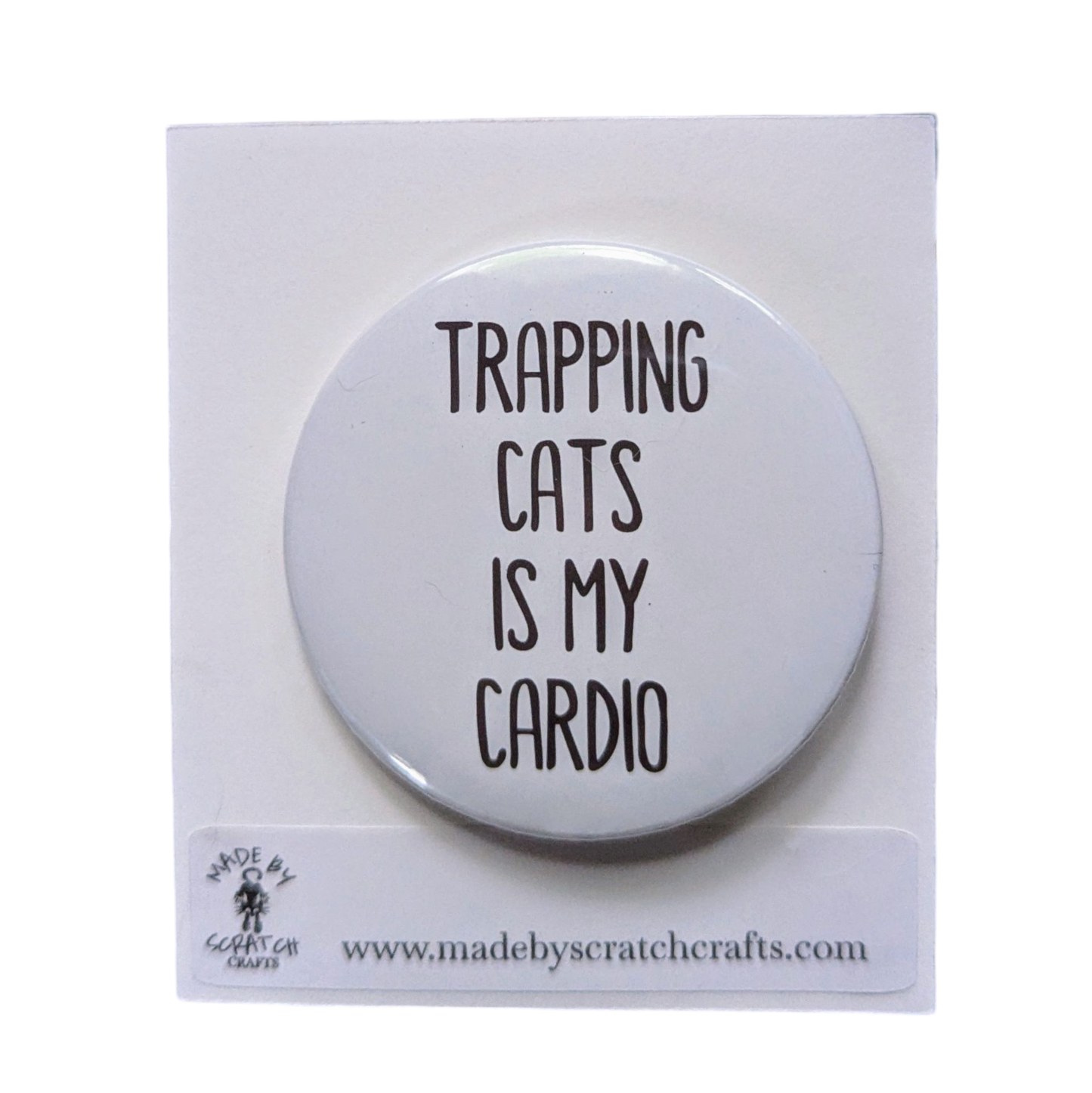 Button badge with 'Trapping cats is my cardio' text on a white background