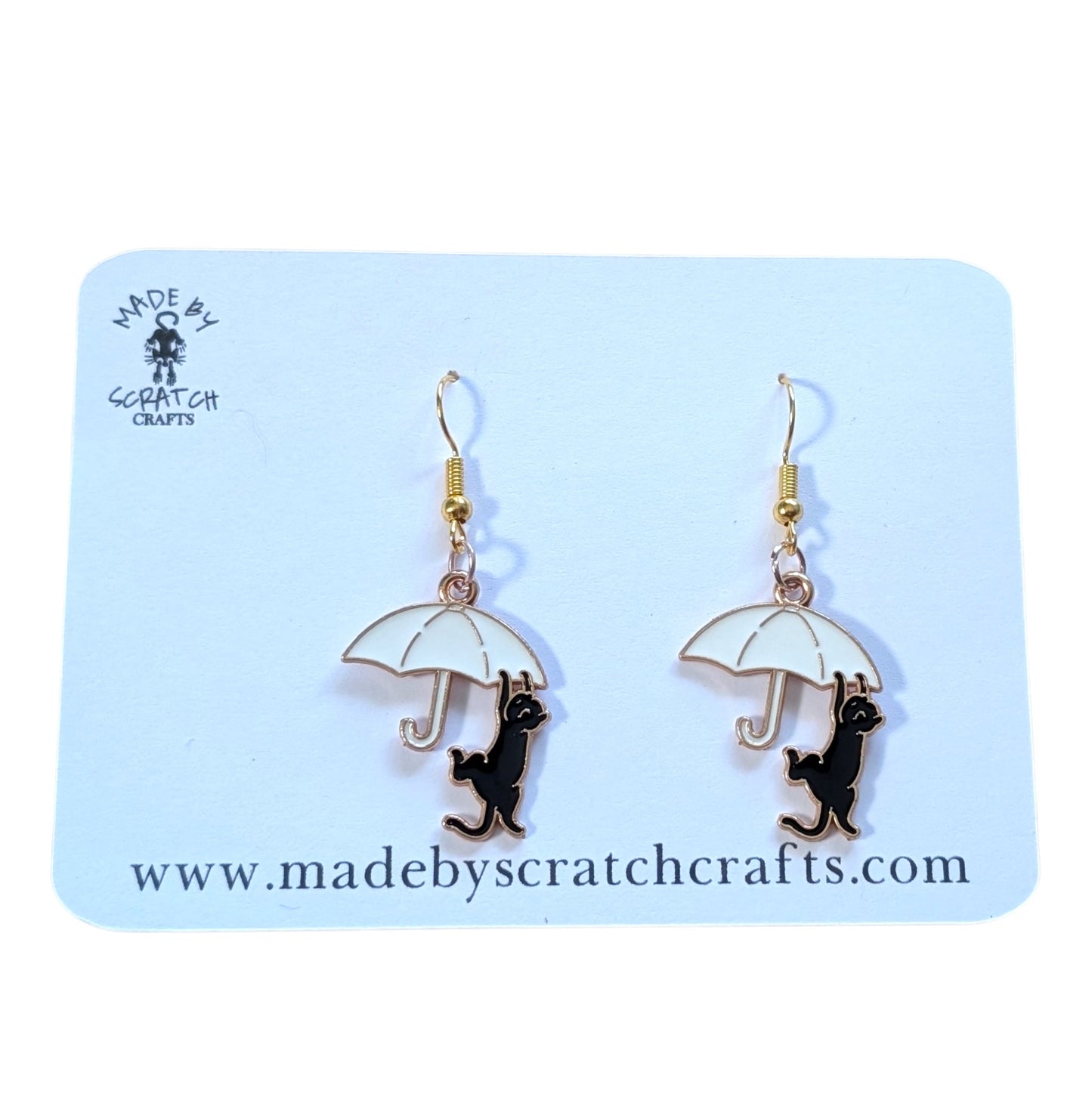 Umbrella and cat earrings on a 'Made by Scratch Crafts' card
