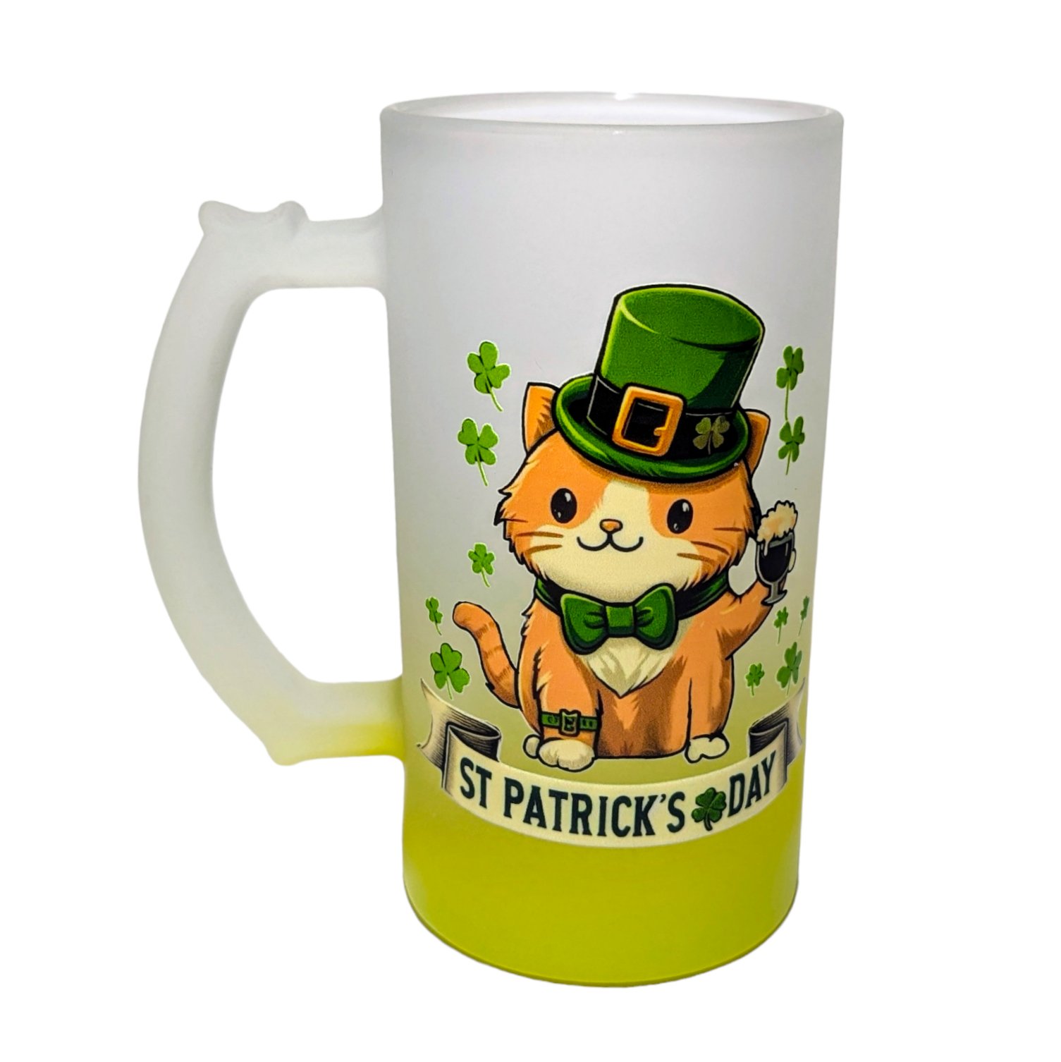 A frosted glass mug with a green ombre effect. A cartoon orange cat wearing a green hat and bowtie is holding a pint of beer and surrounded by four-leaf clovers. The text "ST PATRICK'S DAY" is written in green at the bottom of the mug.