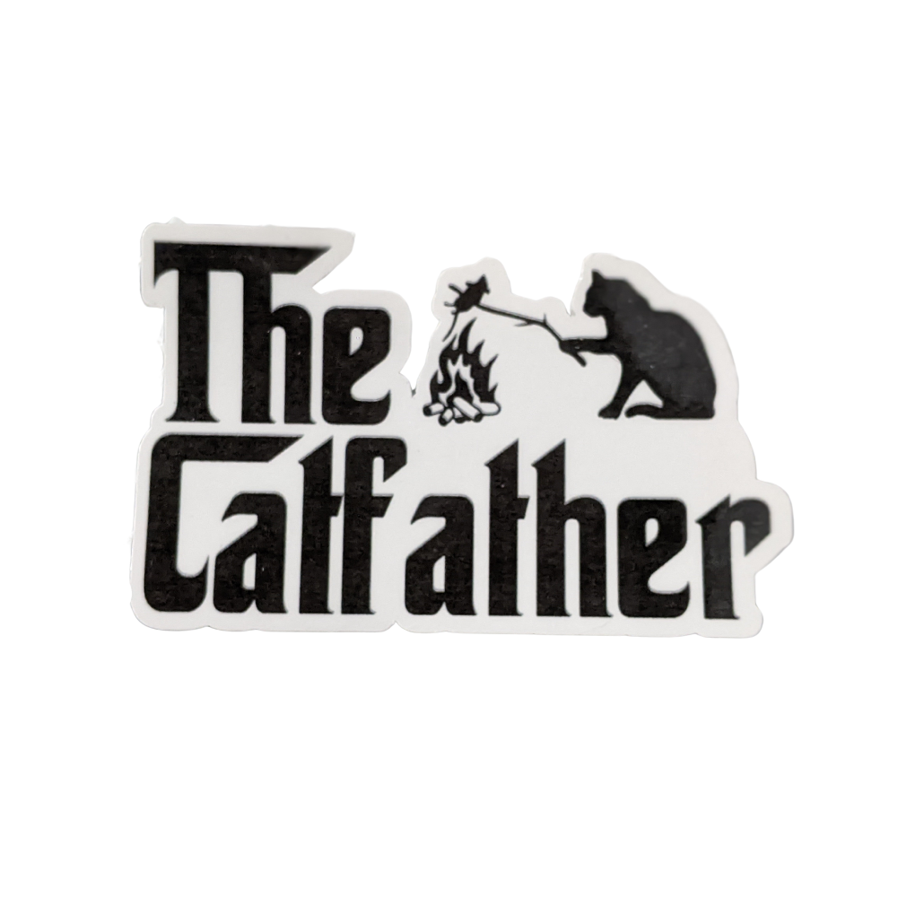 The Catfather vinyl sticker with black text and a cat roasting a marshmallow over a campfire