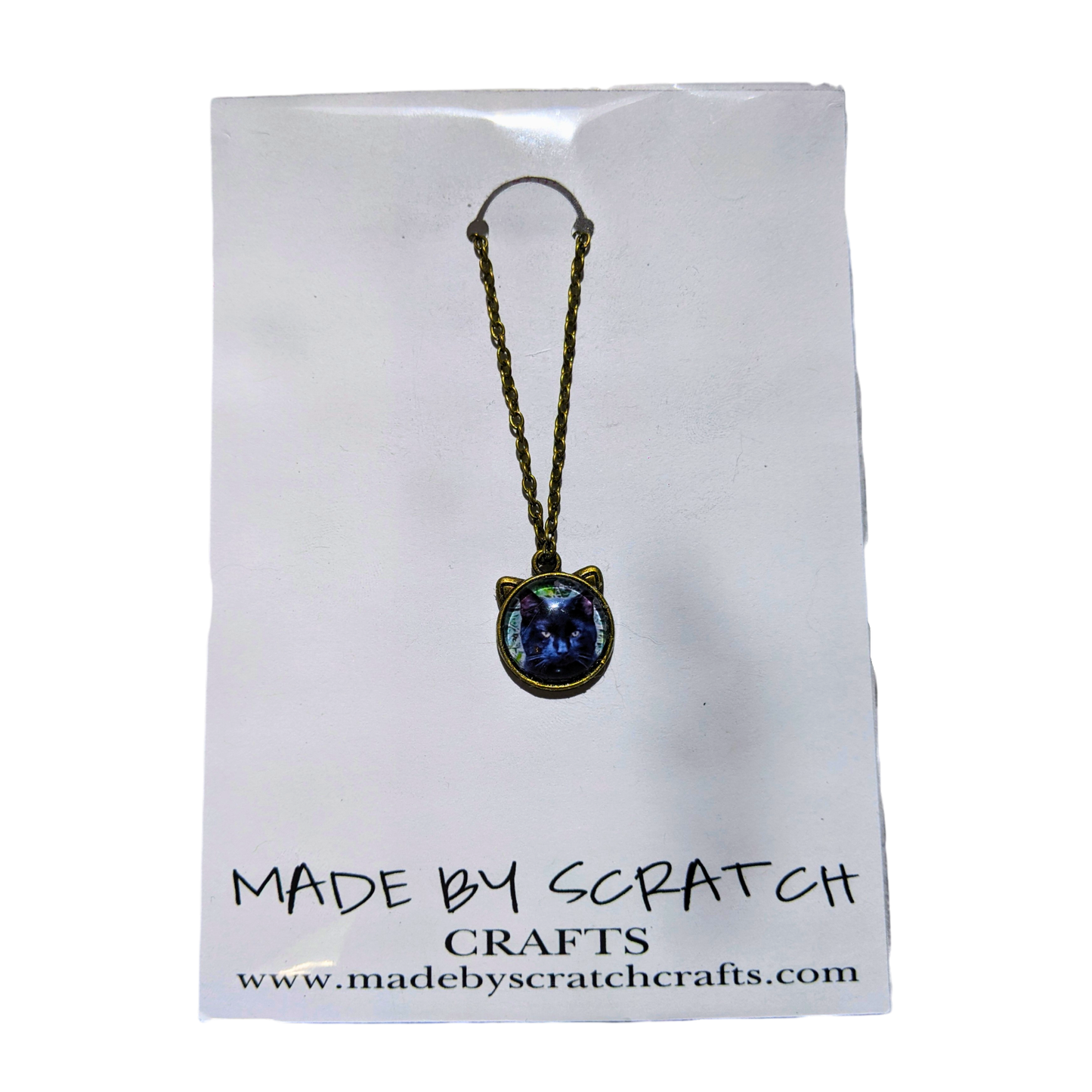 Cat-shaped necklace with photo of cat on a 'Made by Scratch Crafts' card