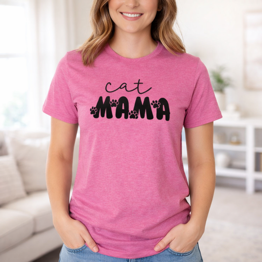 Woman wearing a pink t-shirt with 'cat MAMA' text in a living room setting