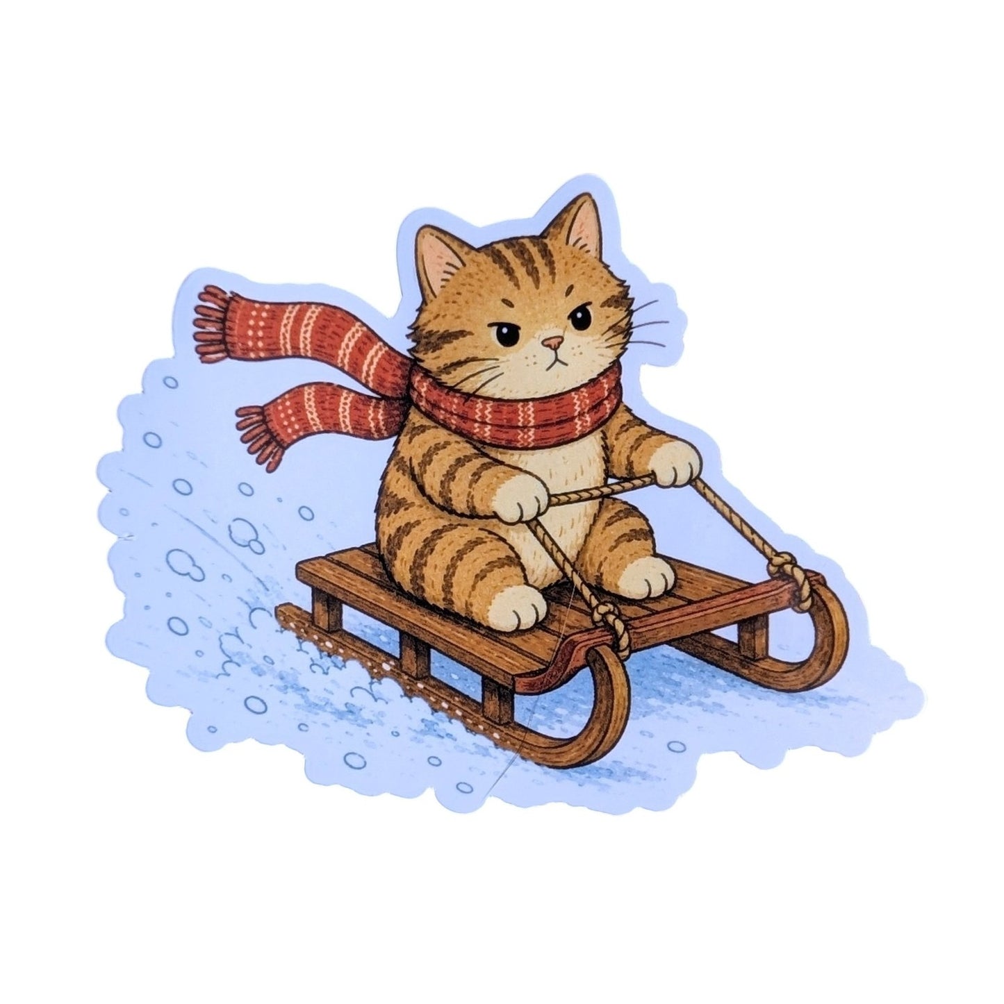 A cute cartoon sticker or decal of an orange tabby cat wearing a red and orange striped scarf, sitting on a wooden sled and pushing snow in the back, isolated on a white background.