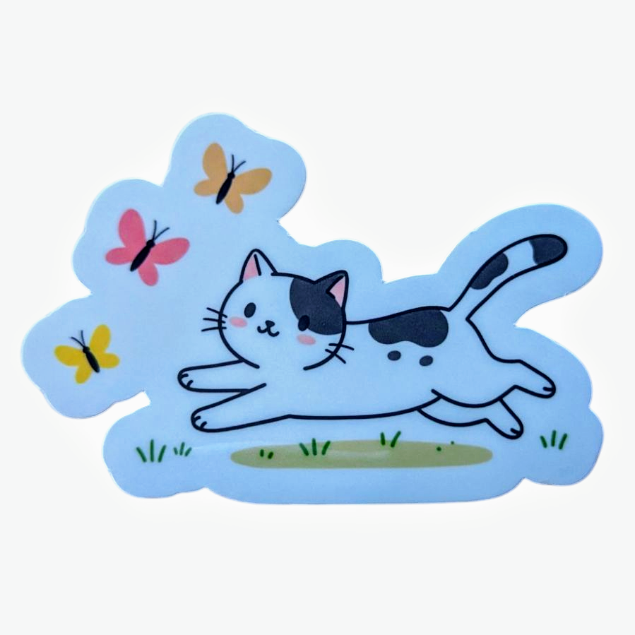 A vinyl sticker featuring a playful black and white kitten chasing colorful butterflies, issued on a blue background.