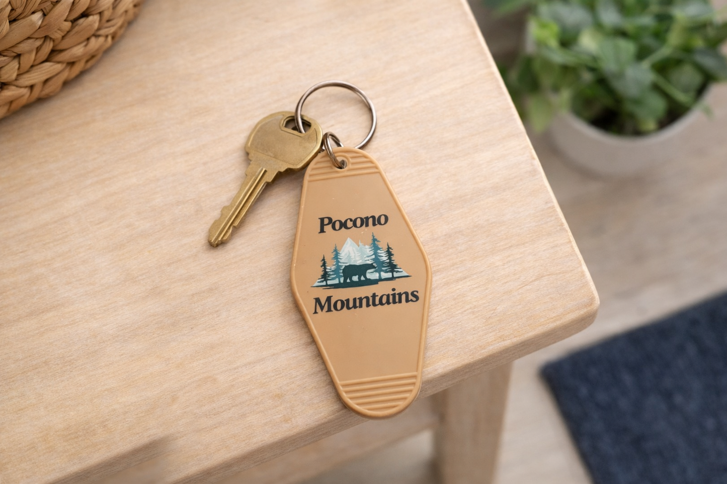 Keychain with 'Pocono Mountains' design on a wooden surface