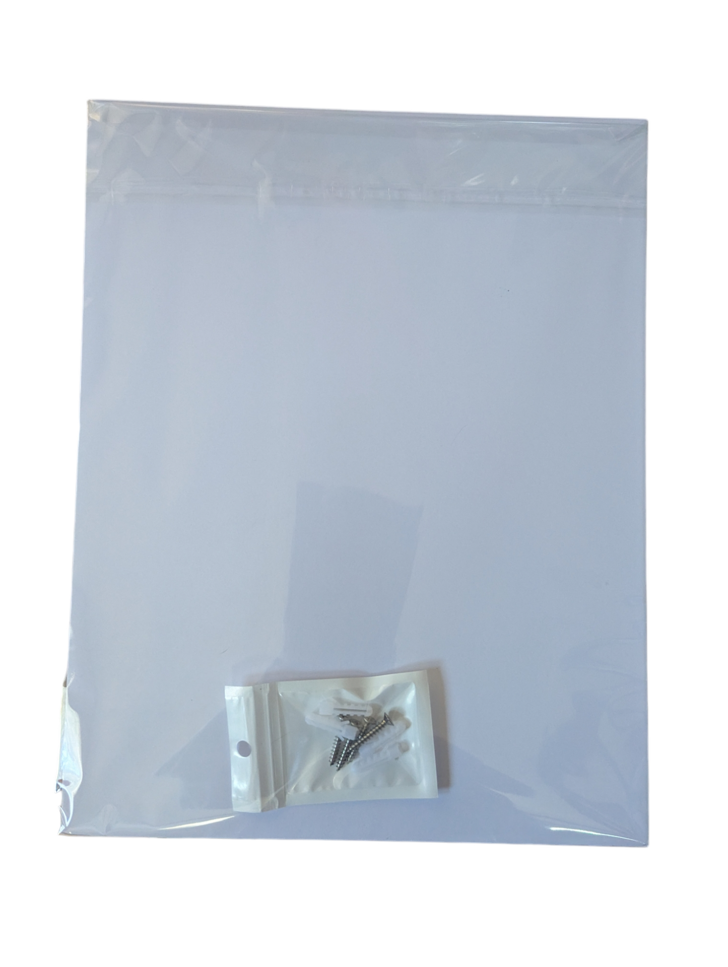 Clear plastic bag with a small white pouch containing a metal object on a white background