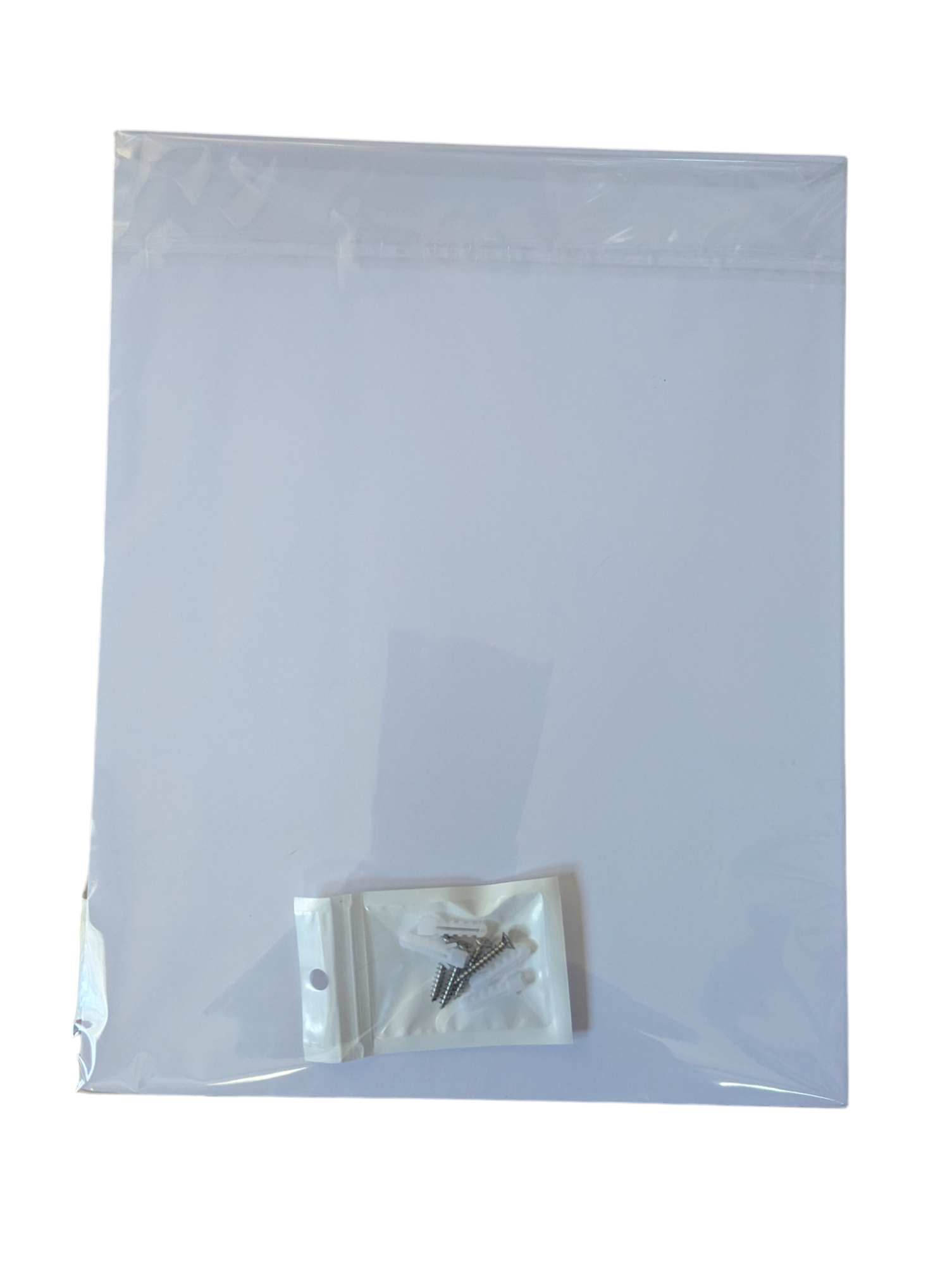 Clear plastic bag with a small white pouch containing a metal object on a white background