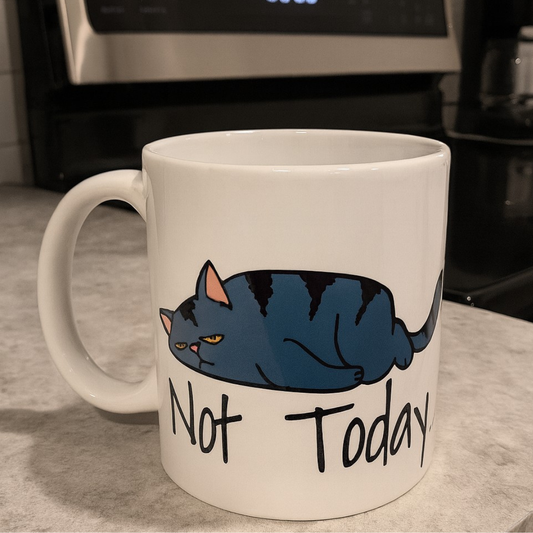 White mug with a cat illustration and 'Not Today' text on a kitchen counter.