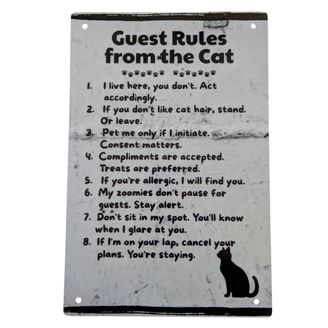 Metal sign with 'Guest Rules from the Cat' text on a white background