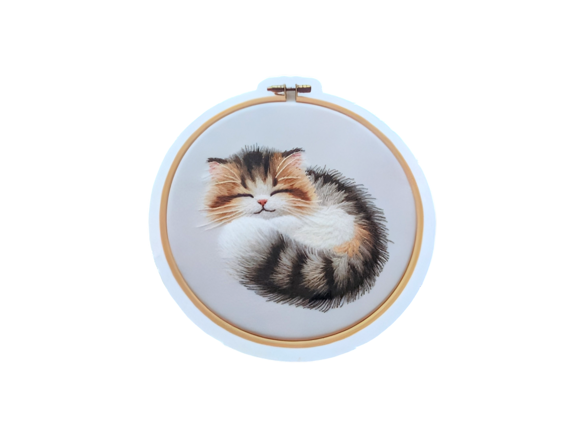 Embroidery hoop with a sleeping cat design on a white background