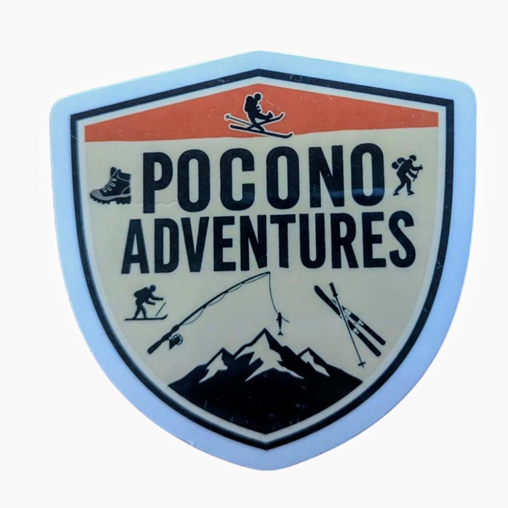 A waterproof vinyl sticker with a shield-shaped design featuring the text 'Pocono Adventures' and icons of outdoor activities such as skiing and mountaineering.
