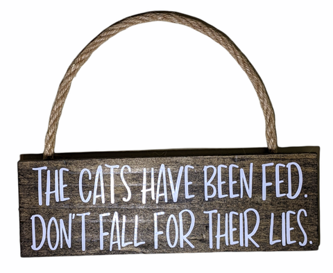 The cats have been fed, dont fall for their lies mini hanging wood dark stain sign