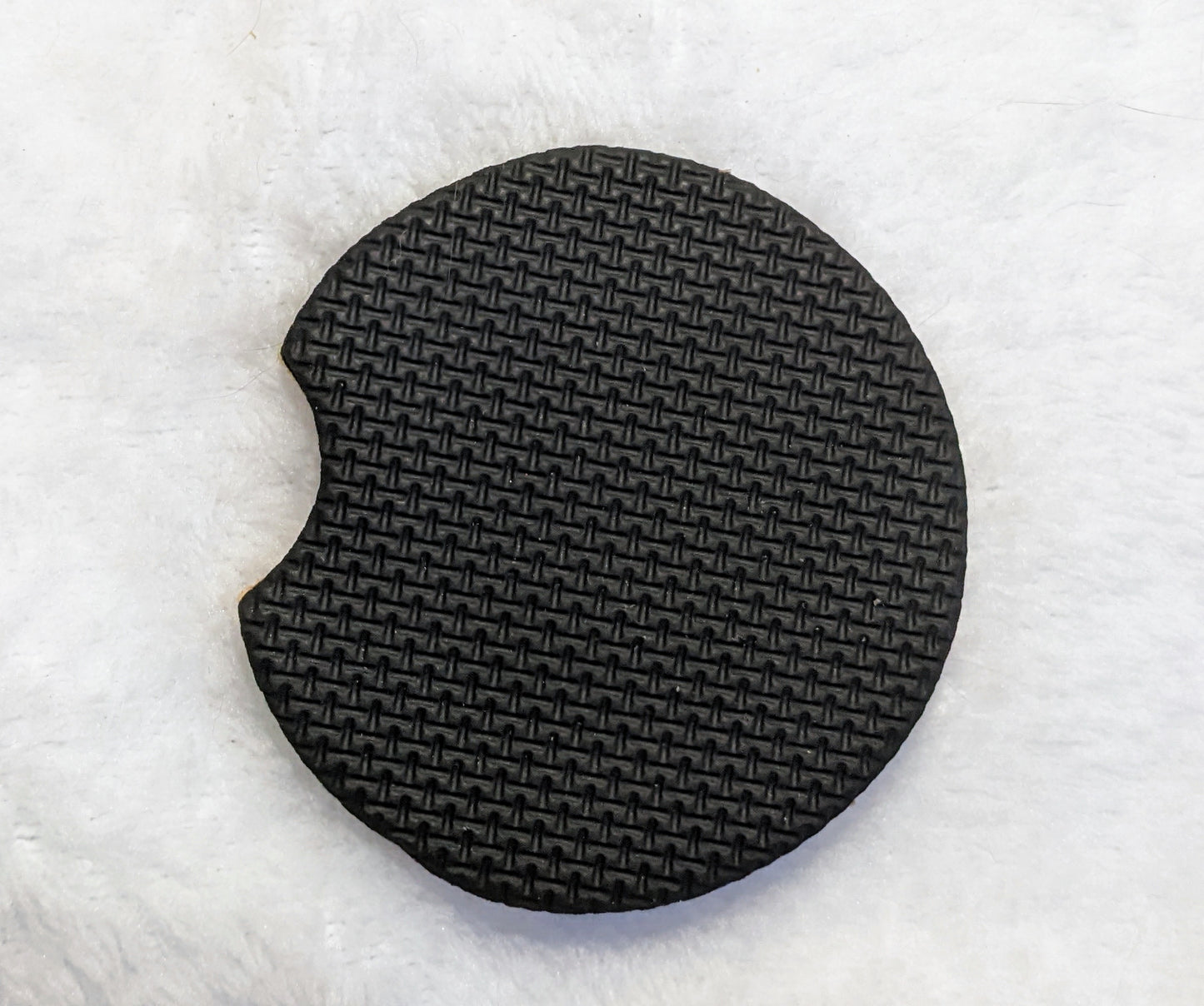 Close-up of textured non-slip backing on neoprene car coaster